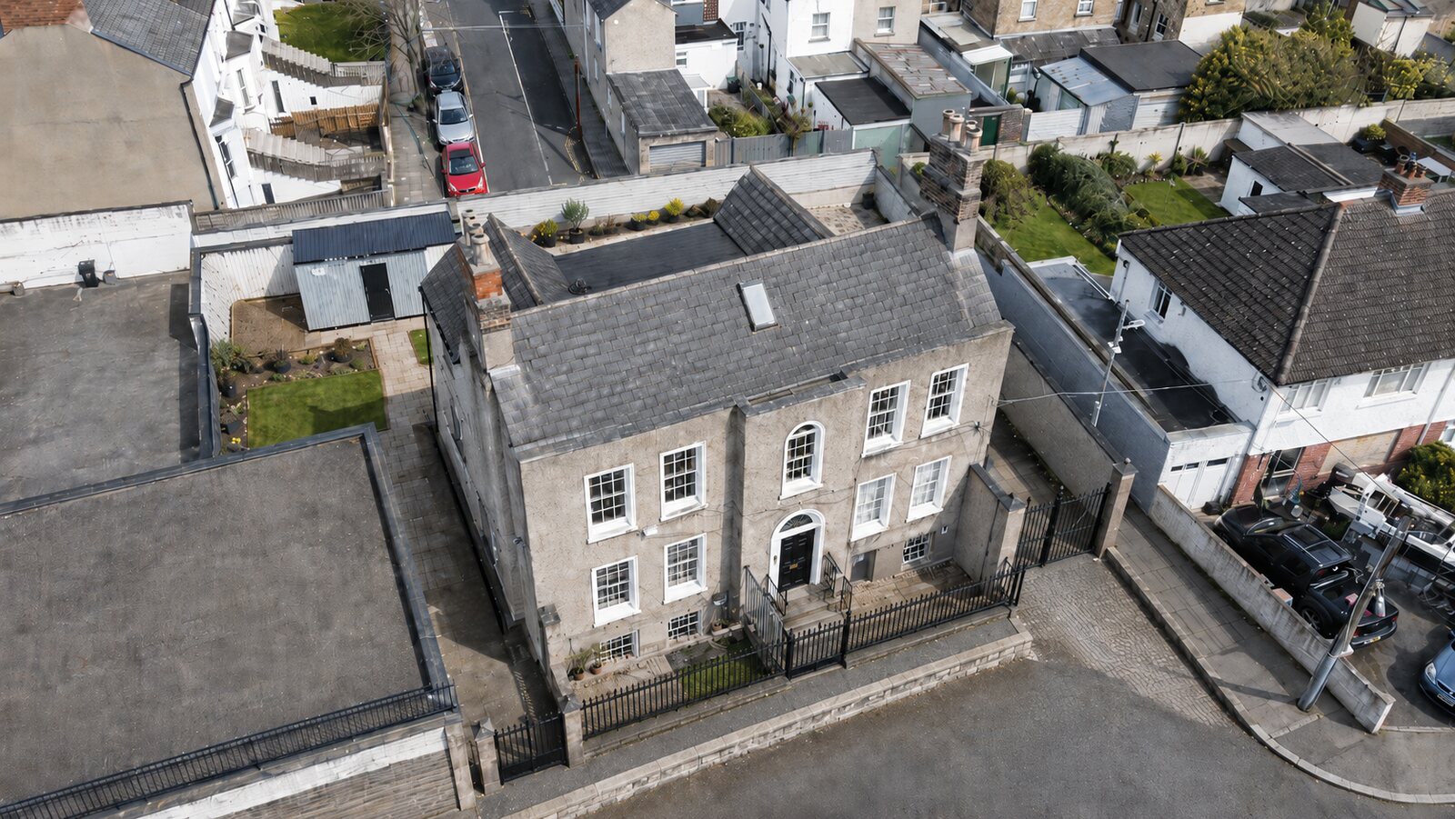 Aerial view of a detached period house and walled garden, Dublin
